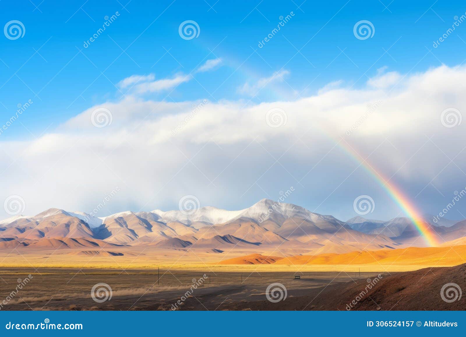 rainbow materializing over a distant mountain range
