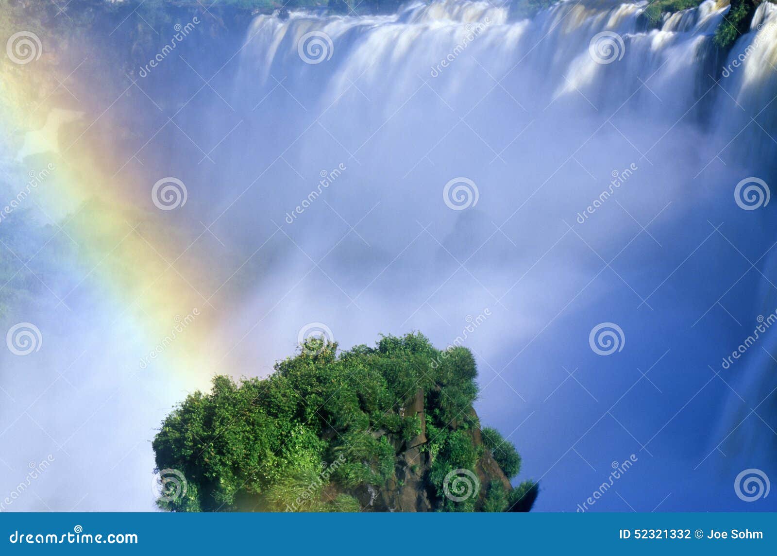 rainbow over iguazu waterfalls in parque nacional iguazu viewed from upper circuit, border of brazil and argentina