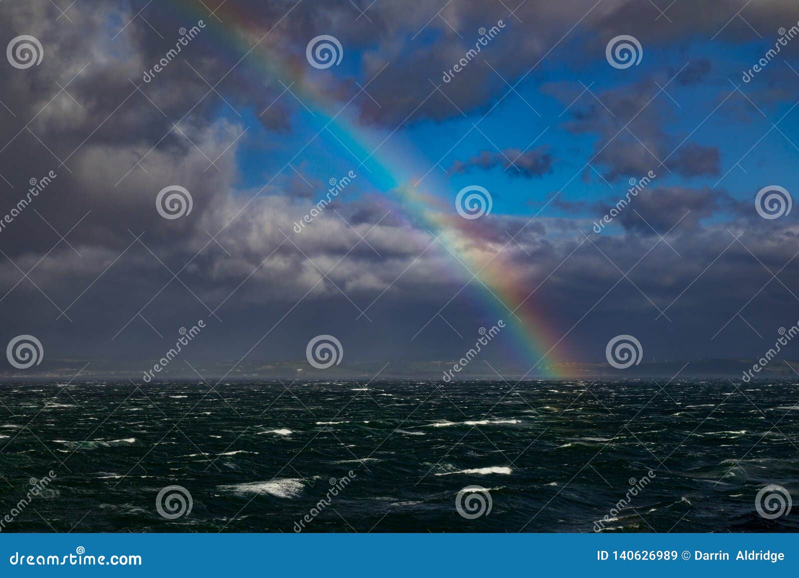 rainbow over rough seas in the english channel