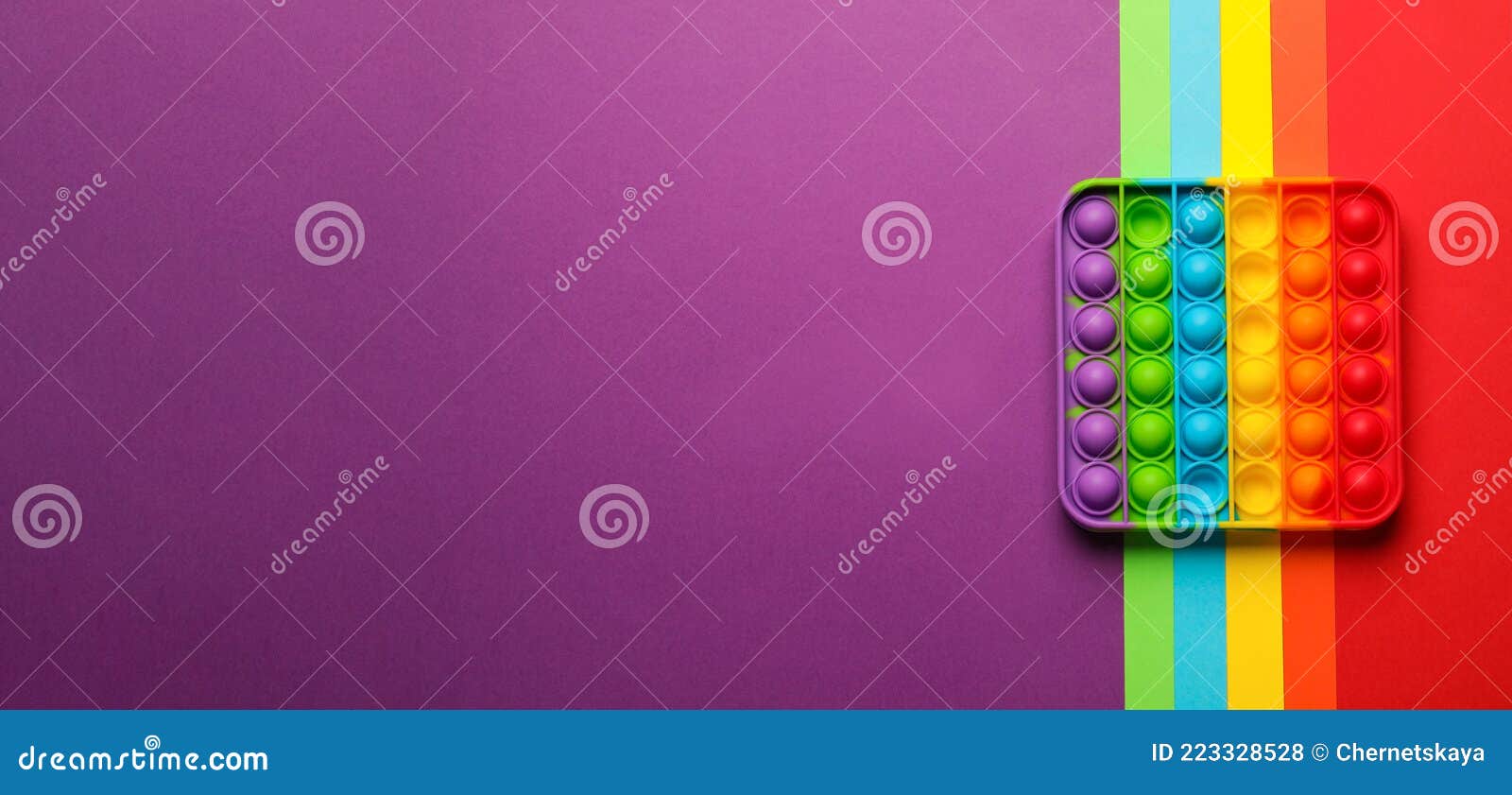 rainbow pop it fidget toy on color background, top view. space for text