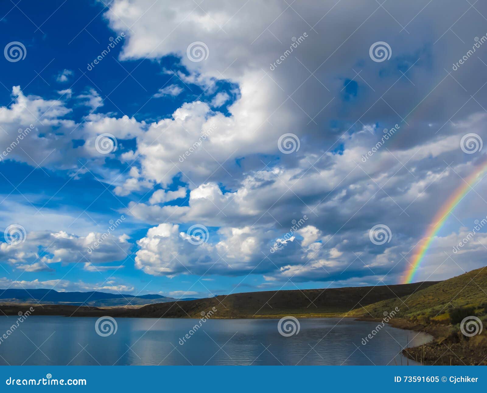 rainbow sky by lake