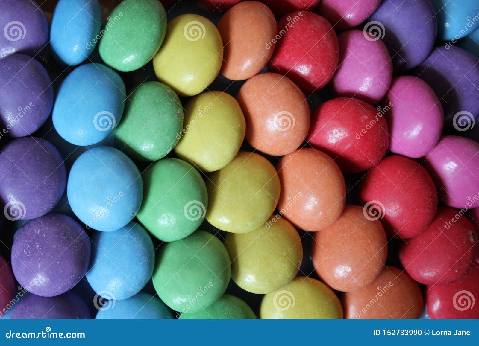 Rainbow Sweet Color Hard Candy in Rows Laid in Rainbow. Stock Photo