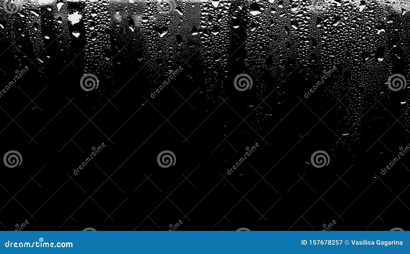 raindrops on the surface of the window panes with a black background. natural rain pattern on the glass. light penetrates through