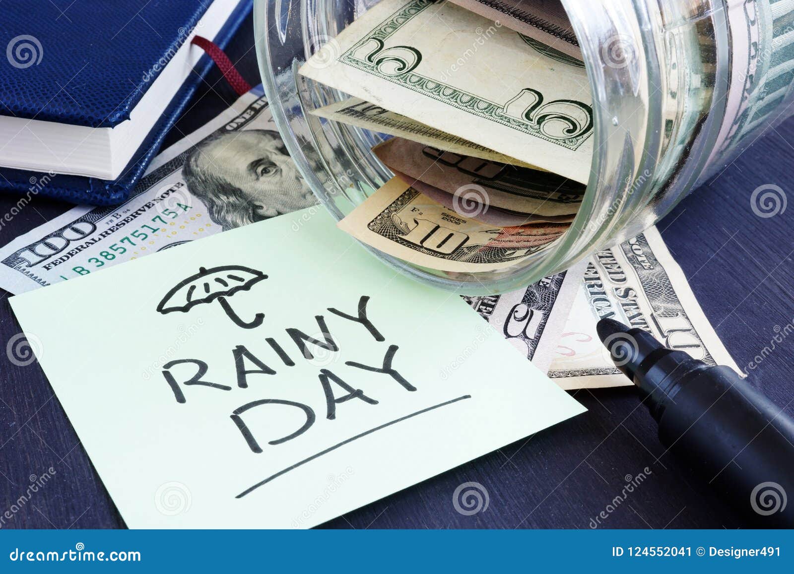 rainy day fund savings. jar with dollar bills.