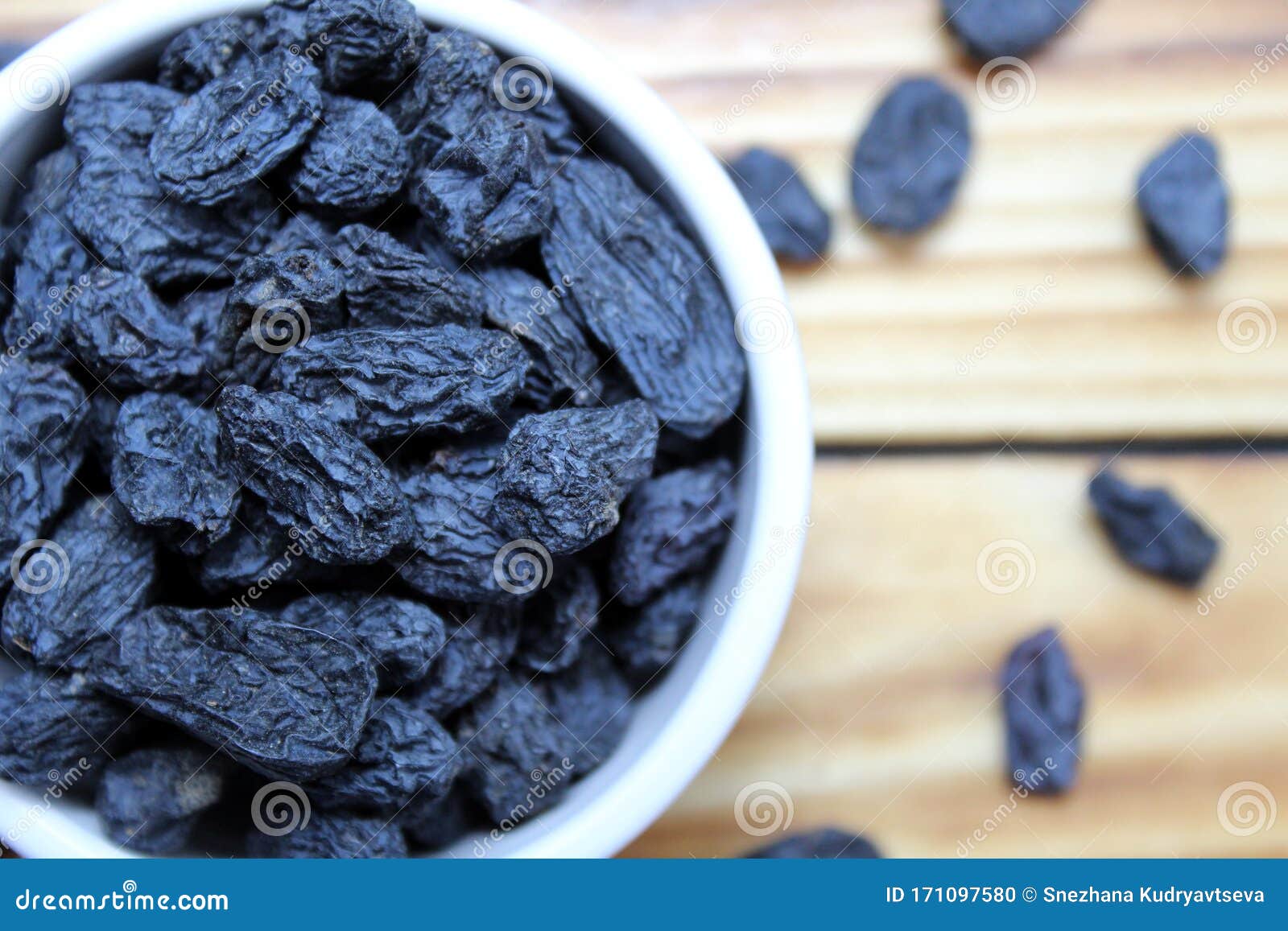 Raisins of Dark Blue in a White Plate Stock Photo - Image of meal ...