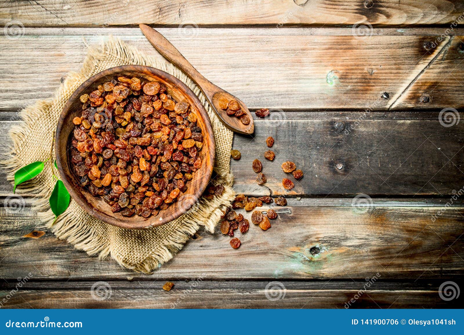 Raisins in bowl. On a Wooden background
