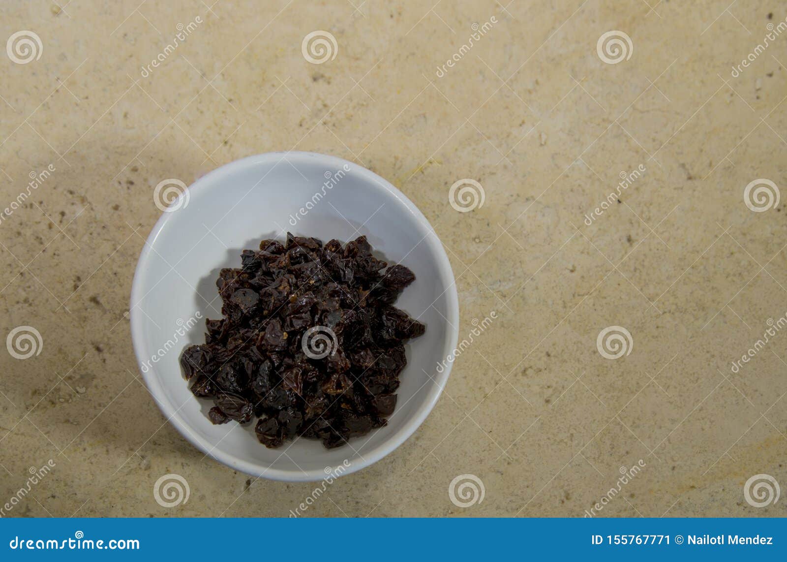 raisins on white plate, ingredient of & x22;chile en nogada& x22;, typical dish of gastronomy in puebla, mexico