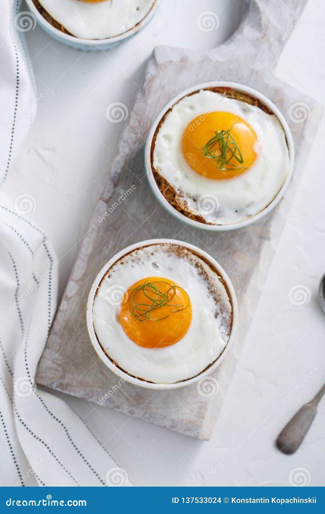 Ramekins Baked Eggs on White Background, Top View Stock Photo Image