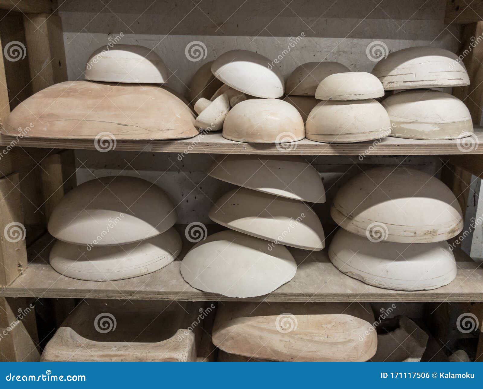 Range of Pottery Molds on a Wooden Shelf in Potters Studio. for