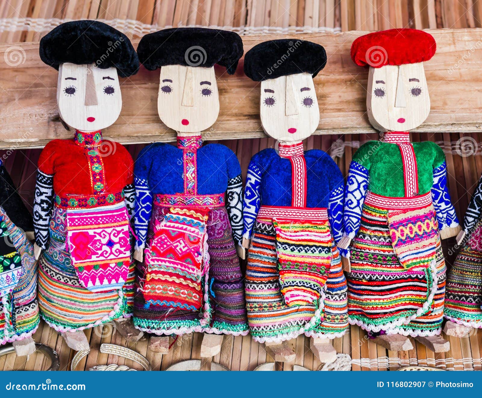 La rangée des poupées en bois noires et rouges de Dzao portant les vêtements traditionnels, peut marché de Cau, Vietnam du nord