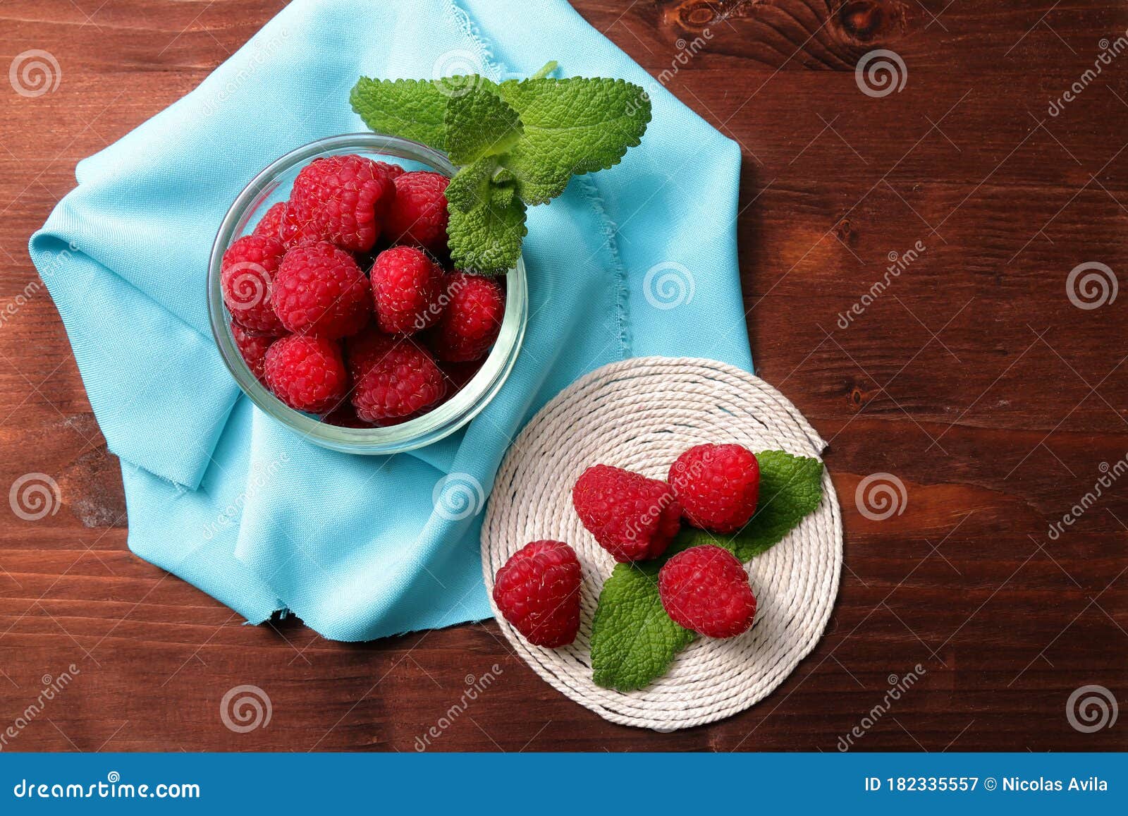 raspberries in a glass container and on a string circle