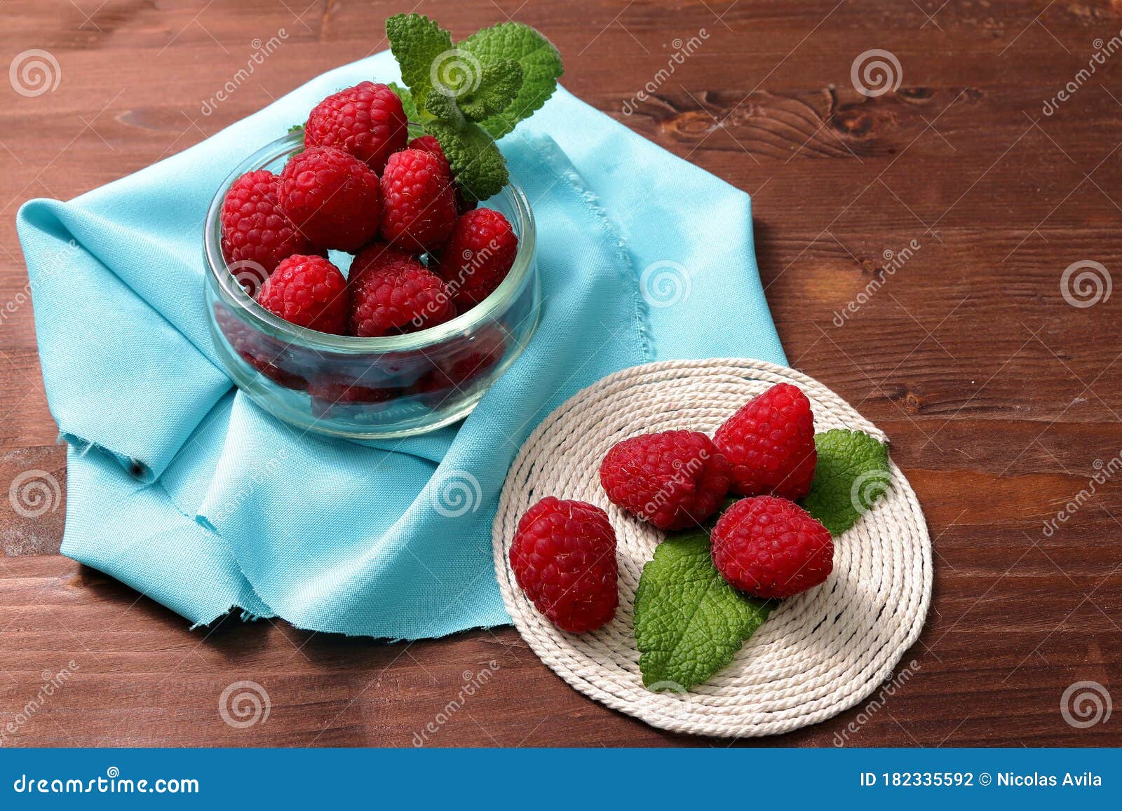 raspberries in a glass container and on a string circle