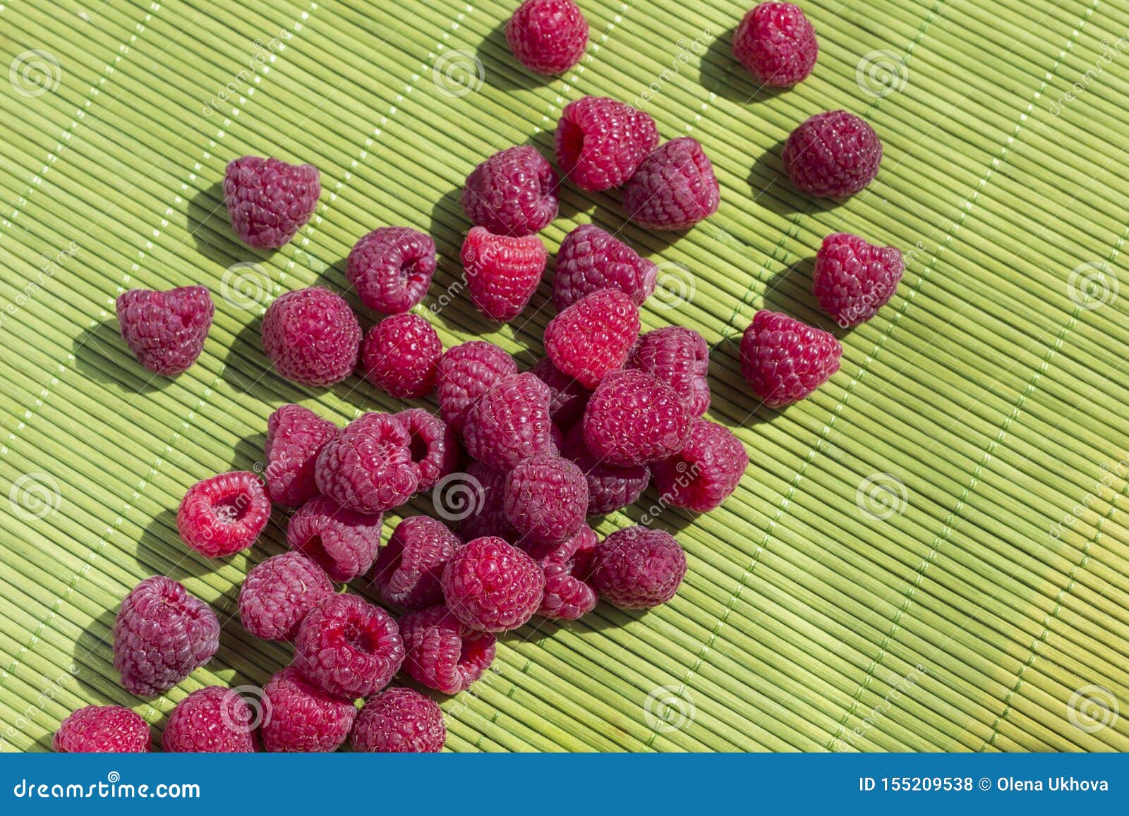 raspberry berries on a green background. top view