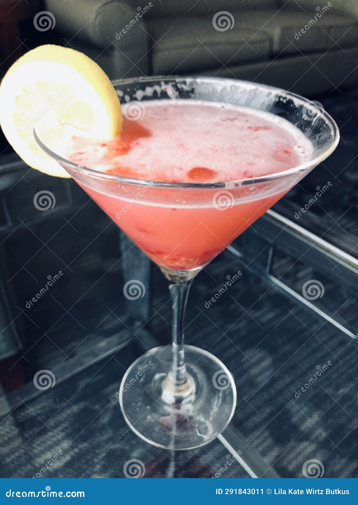raspberry lemon drop martini.. perfect cool refreshing cocktail with slice of lemon garnish