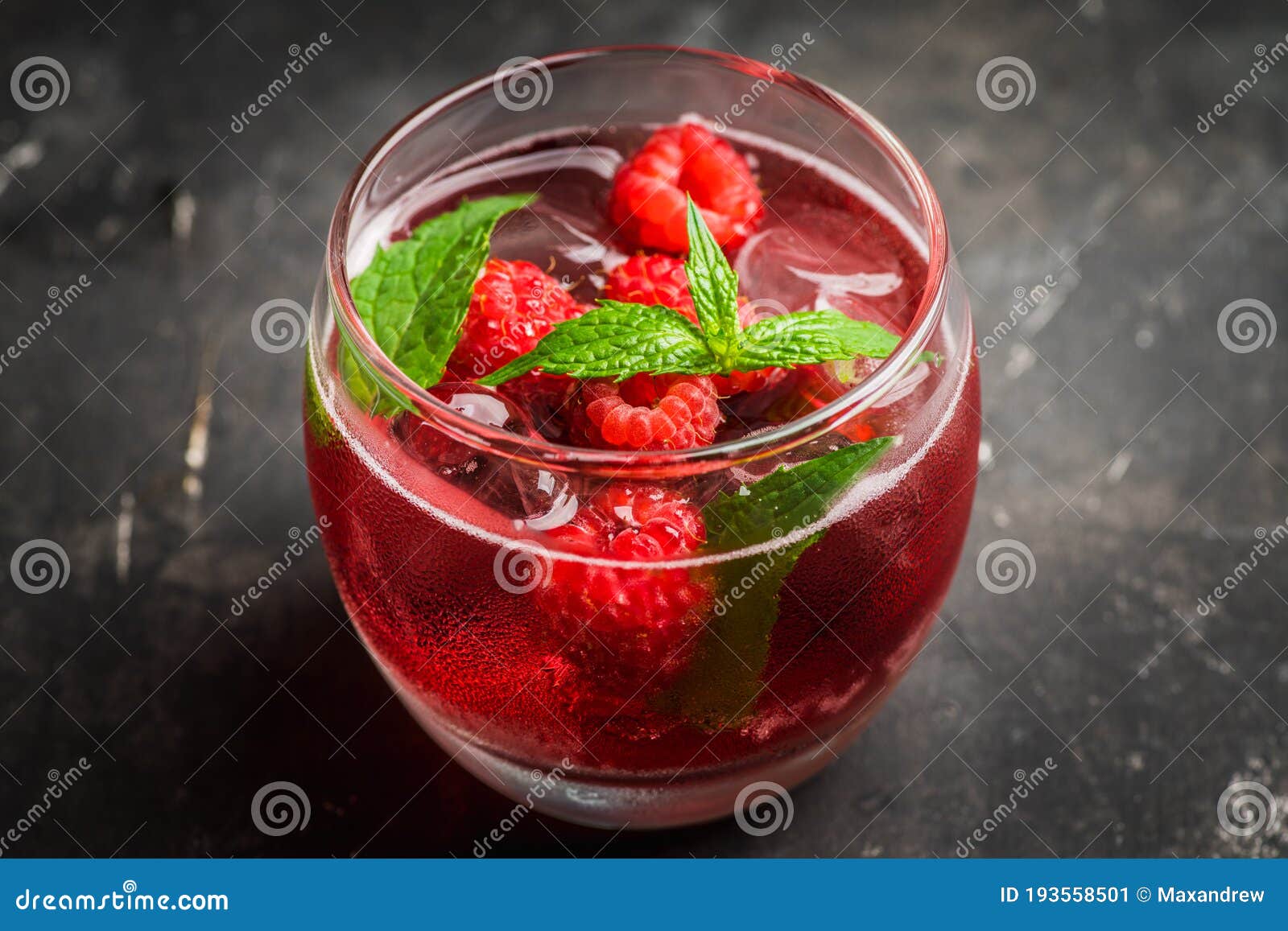 Raspberry and Mint Cocktail in Glass on the Rustic Background Stock