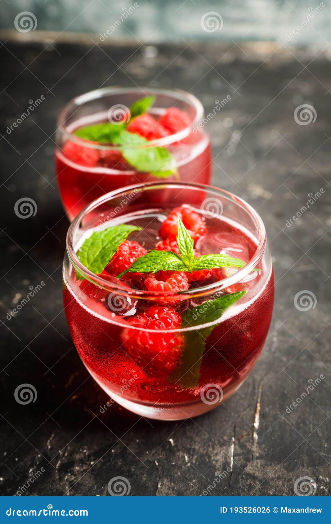 Raspberry and Mint Cocktail in Glass on the Rustic Background Stock