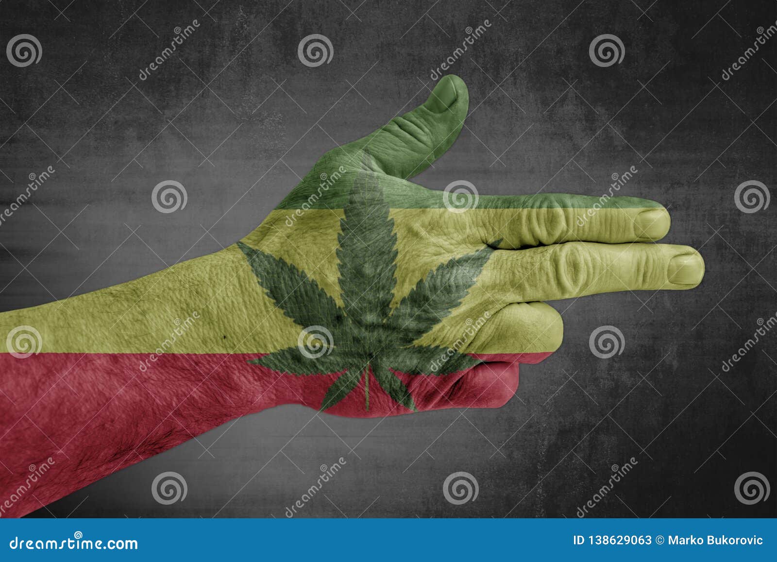 rasta flag painted on male hand like a gun