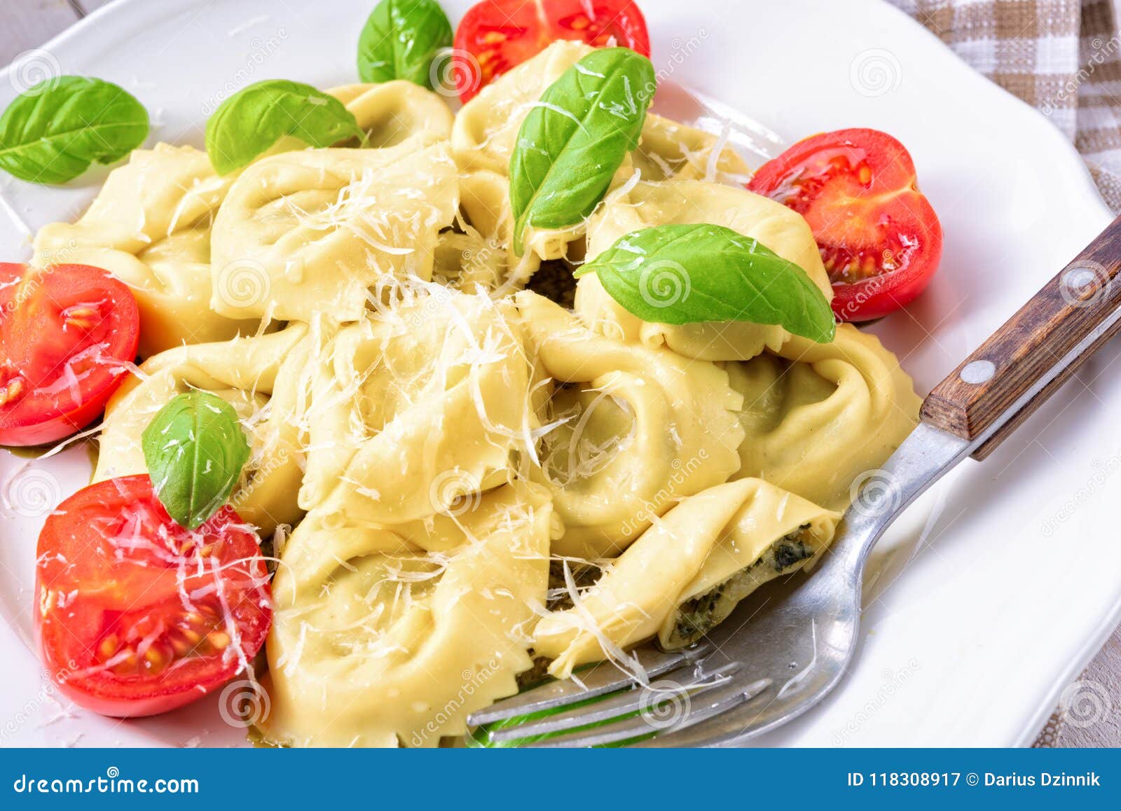 Ravioli with Spinach Filling, Grated Cheese and Cocktail Tomatoes Stock