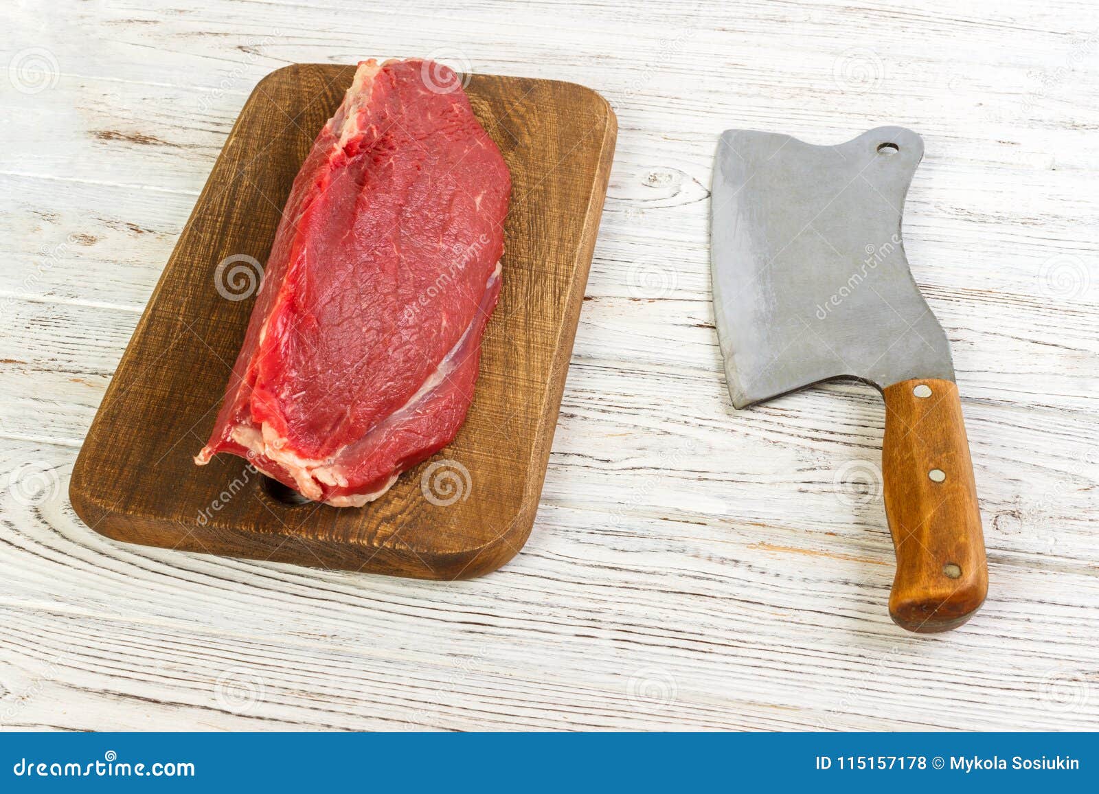 Raw Beef Meat on Cutting Board with Old Vintage Cleaver Stock Photo