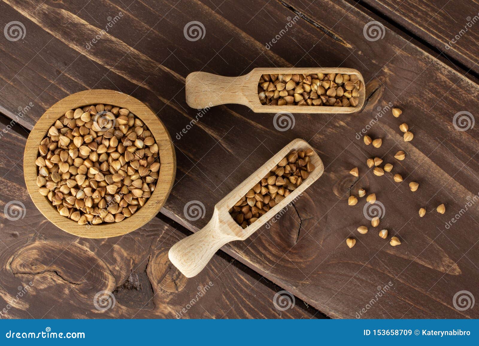 raw buckwheat grain on brown wood