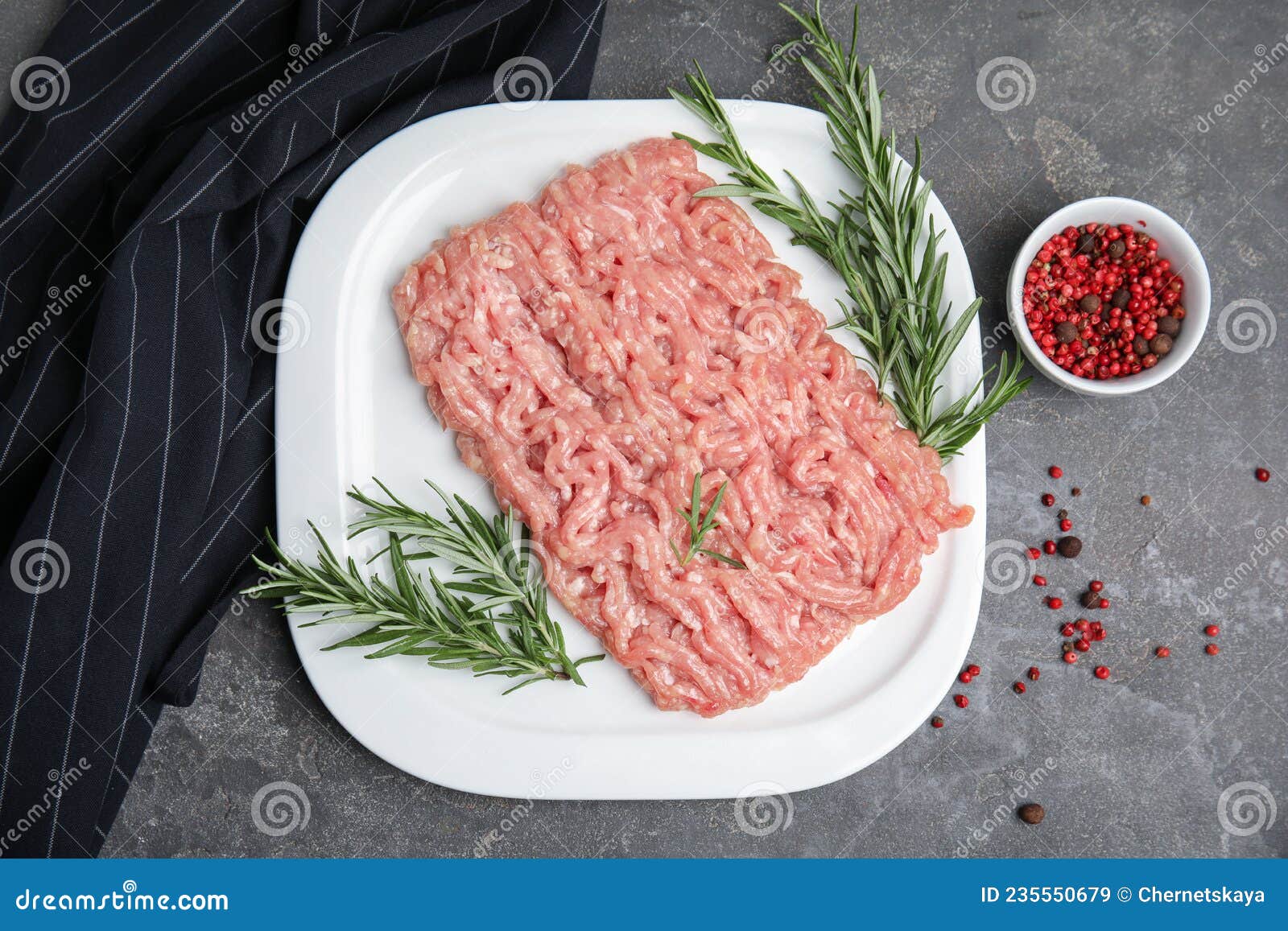 Raw Chicken Minced Meat with Rosemary and Spices on Grey Table, Flat