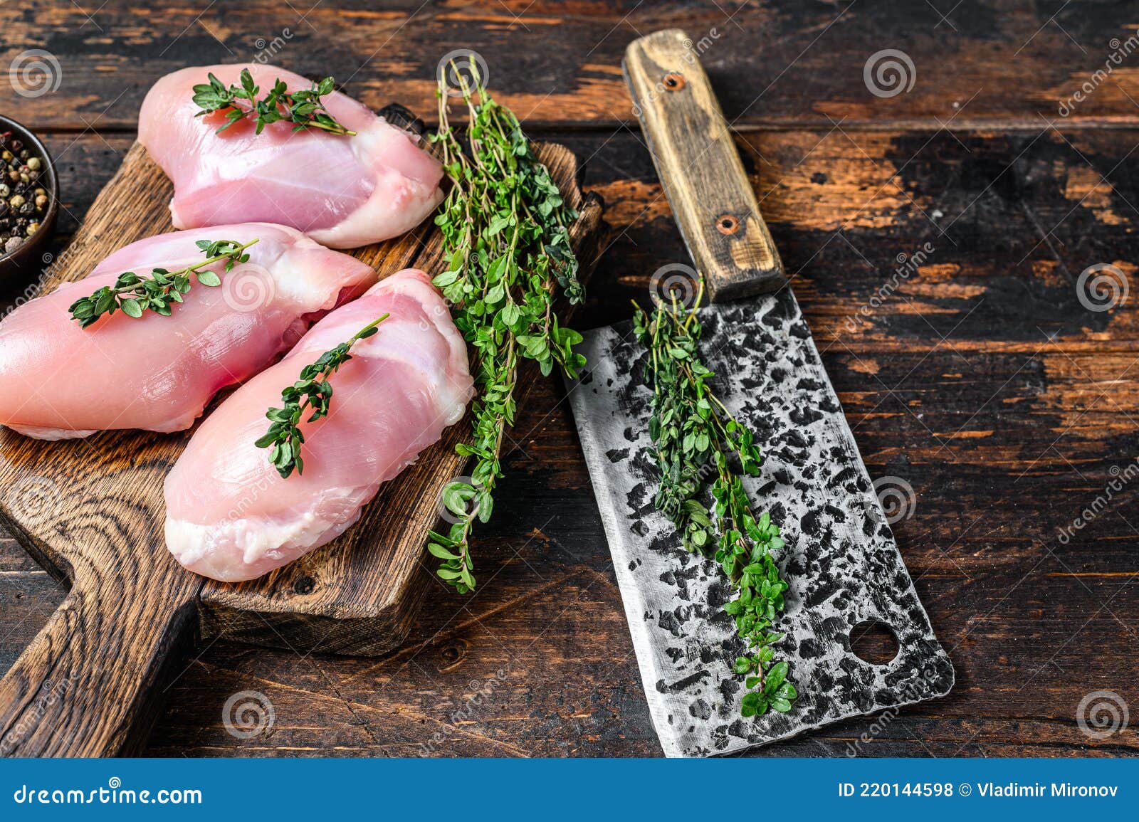 Raw Chicken Skinless Thigh Fillet on a Wooden Cutting Board. Black ...