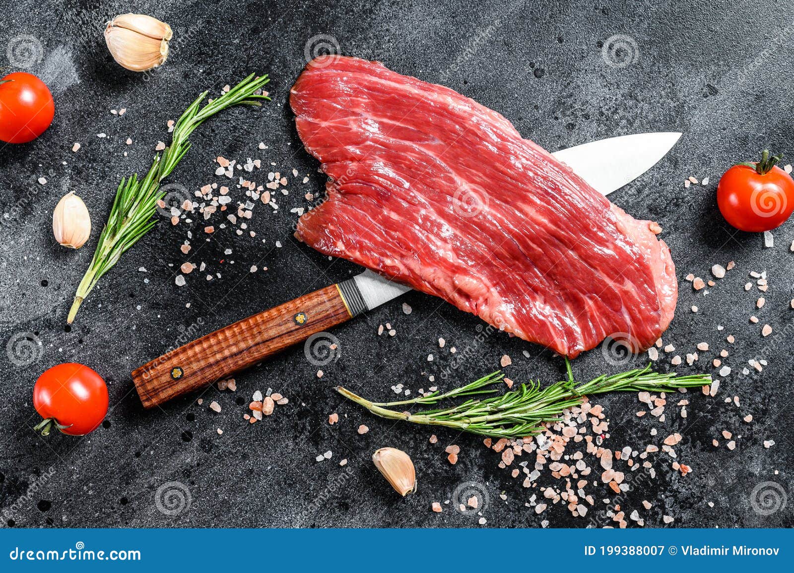 raw flank steak black angus. fresh marble beef meat. black background. top view