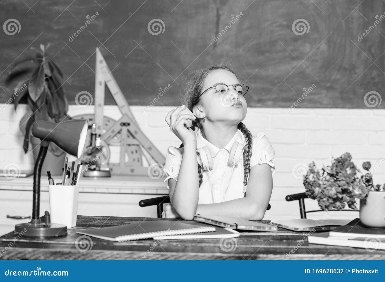 Raw food diet. small girl ready to eat apple. Smart child concept. healthy eating is good. digital age with modern technology. small genius child in classroom. Lunch time. back to school. Einstein.