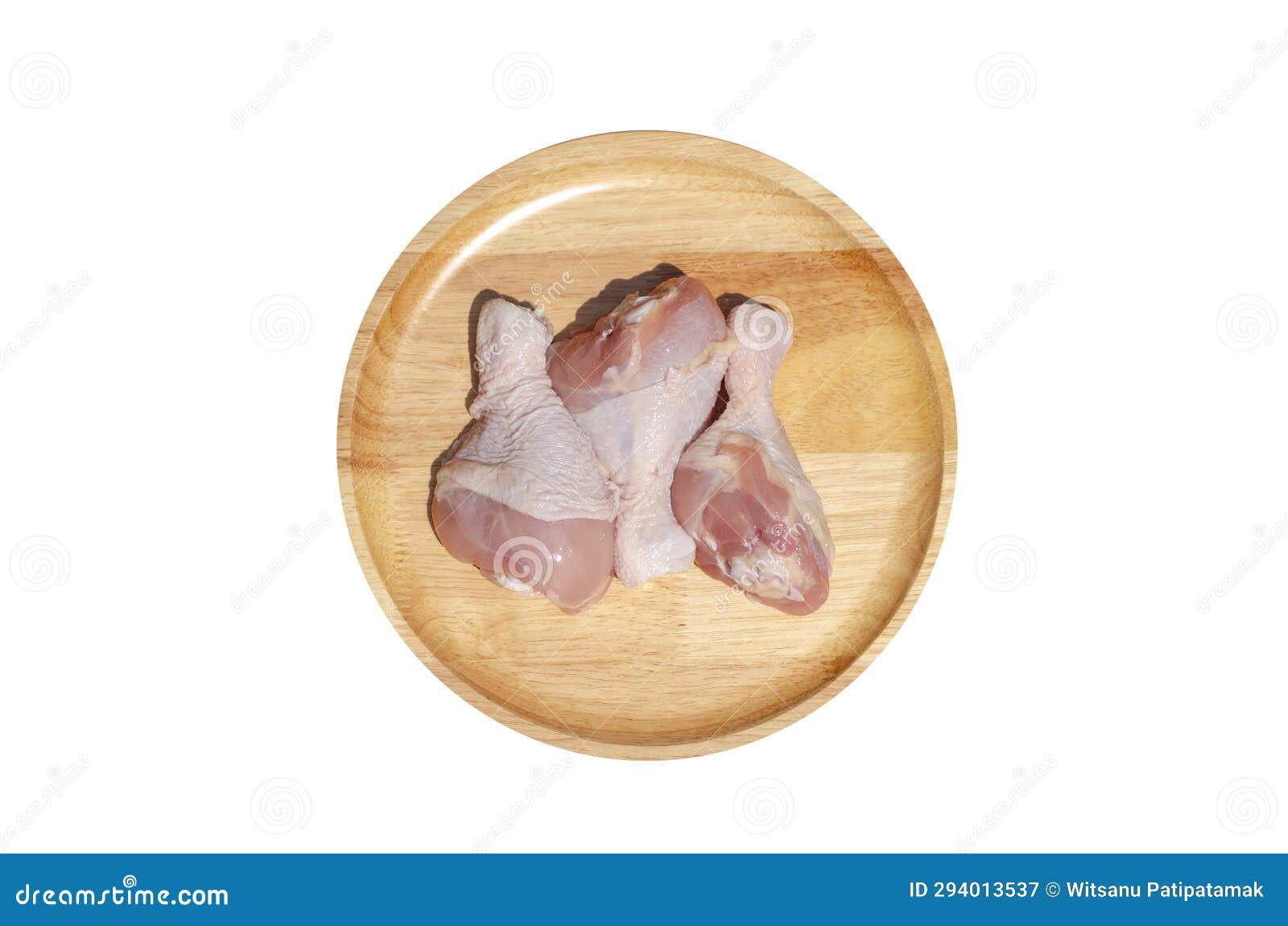 raw fresh chicken wings or drumsticks chicken on a wooden plate  on white background with clipping path. top view