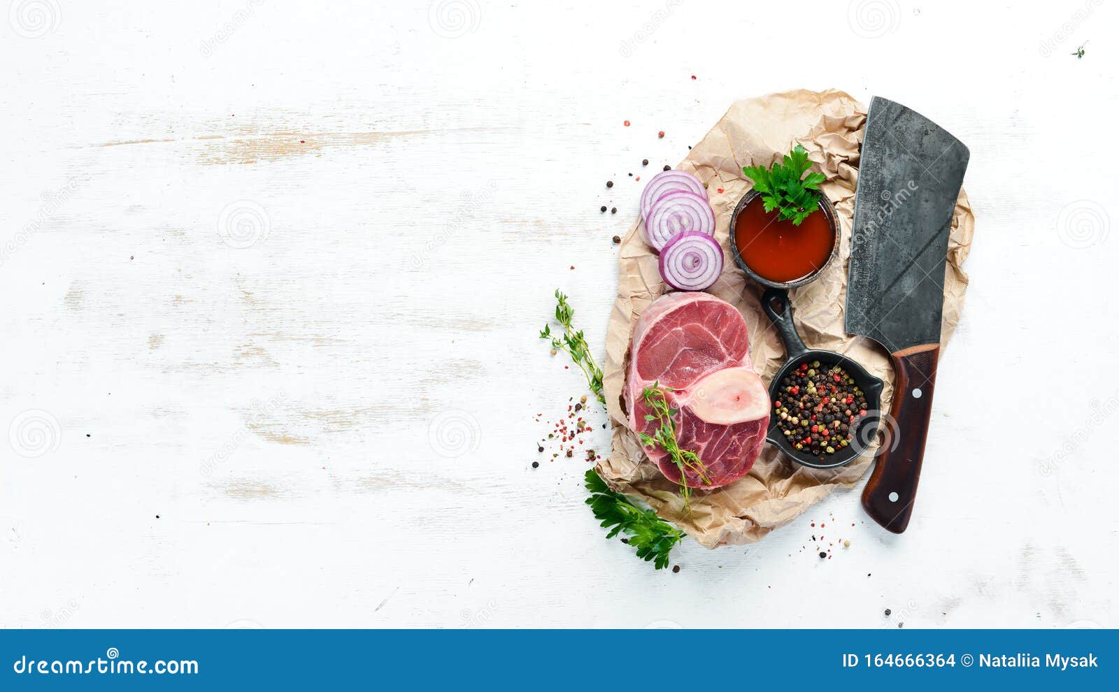 raw fresh cross cut veal shank with spices and herbs on a white background. cheese bif steak ossbo. top view.