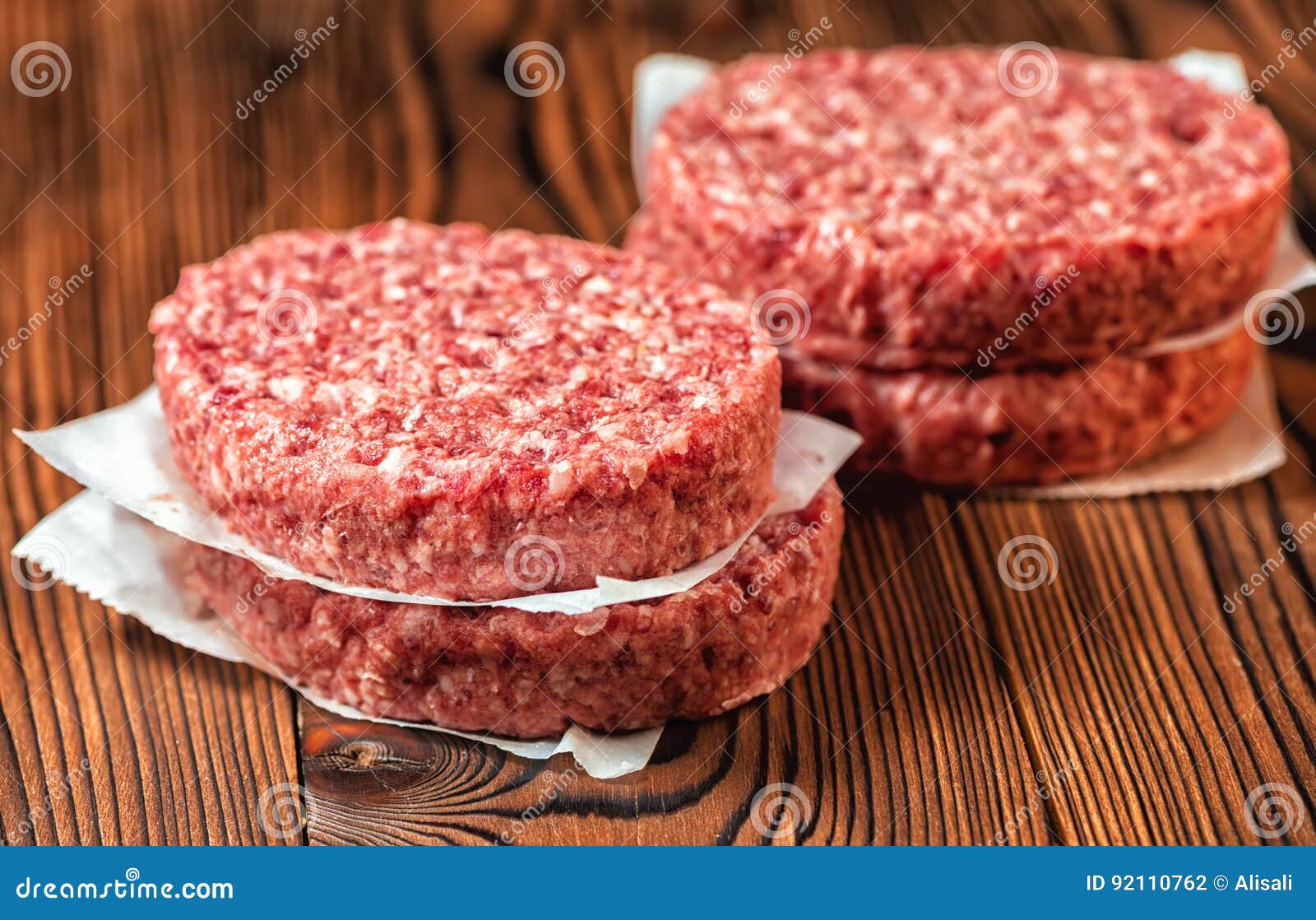 raw ground beef meat hamburger patties on paper,