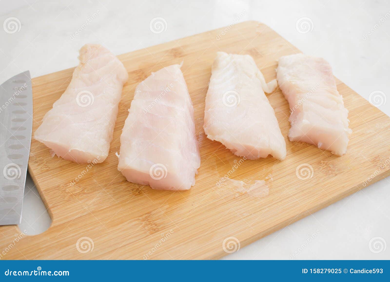 raw grouper fillets on a cutting board