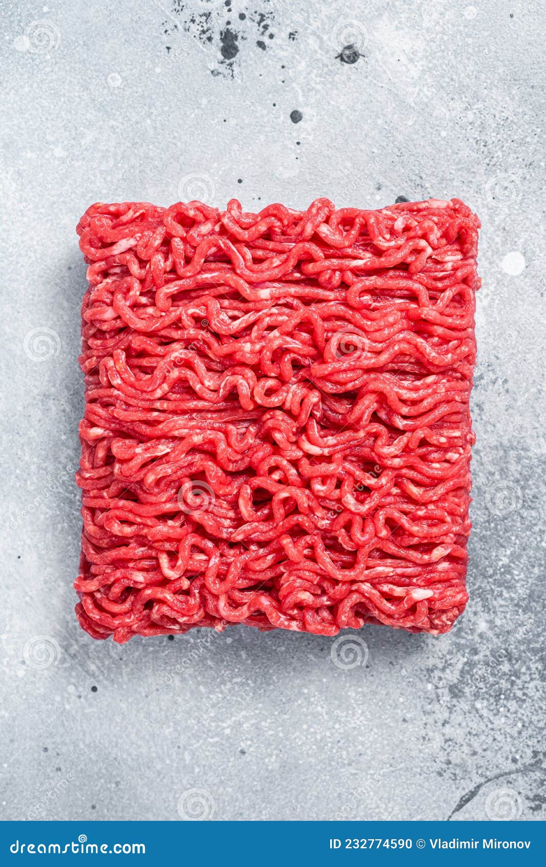 Raw Mince Ground Meat on a Butcher Table. Gray Background Stock Photo
