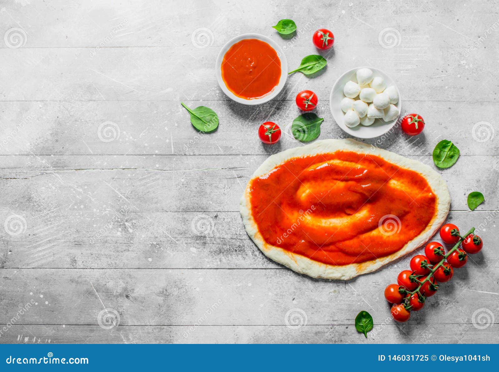 Raw Pizza. Dough with Mozzarella, Tomato Paste and Spinach Stock Image