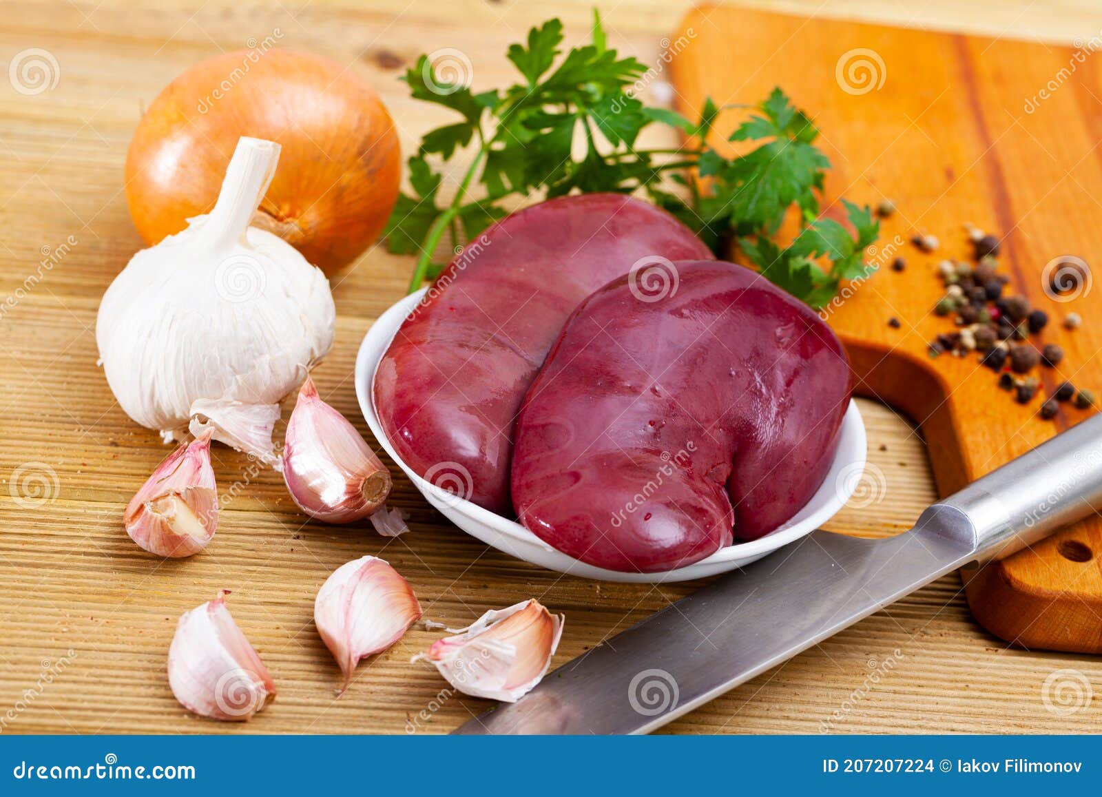 Raw Pork Kidney with Garlic and Greens before Cooking Stock Photo