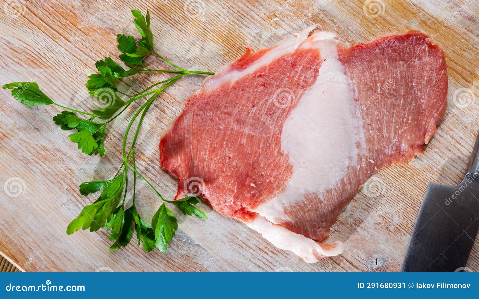 raw pork secreto fillet and greens