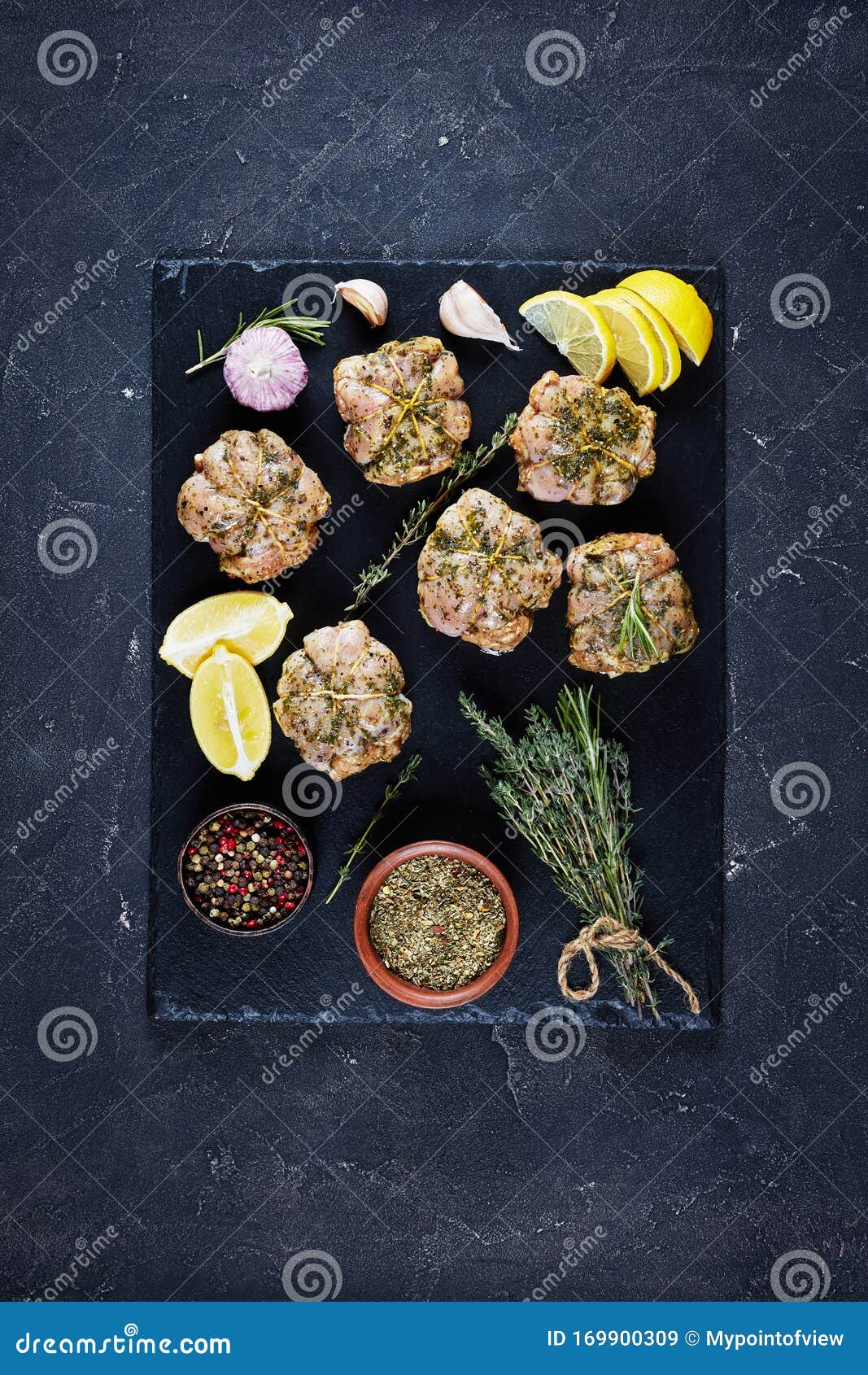 raw rabbit ballotines on a slate tray