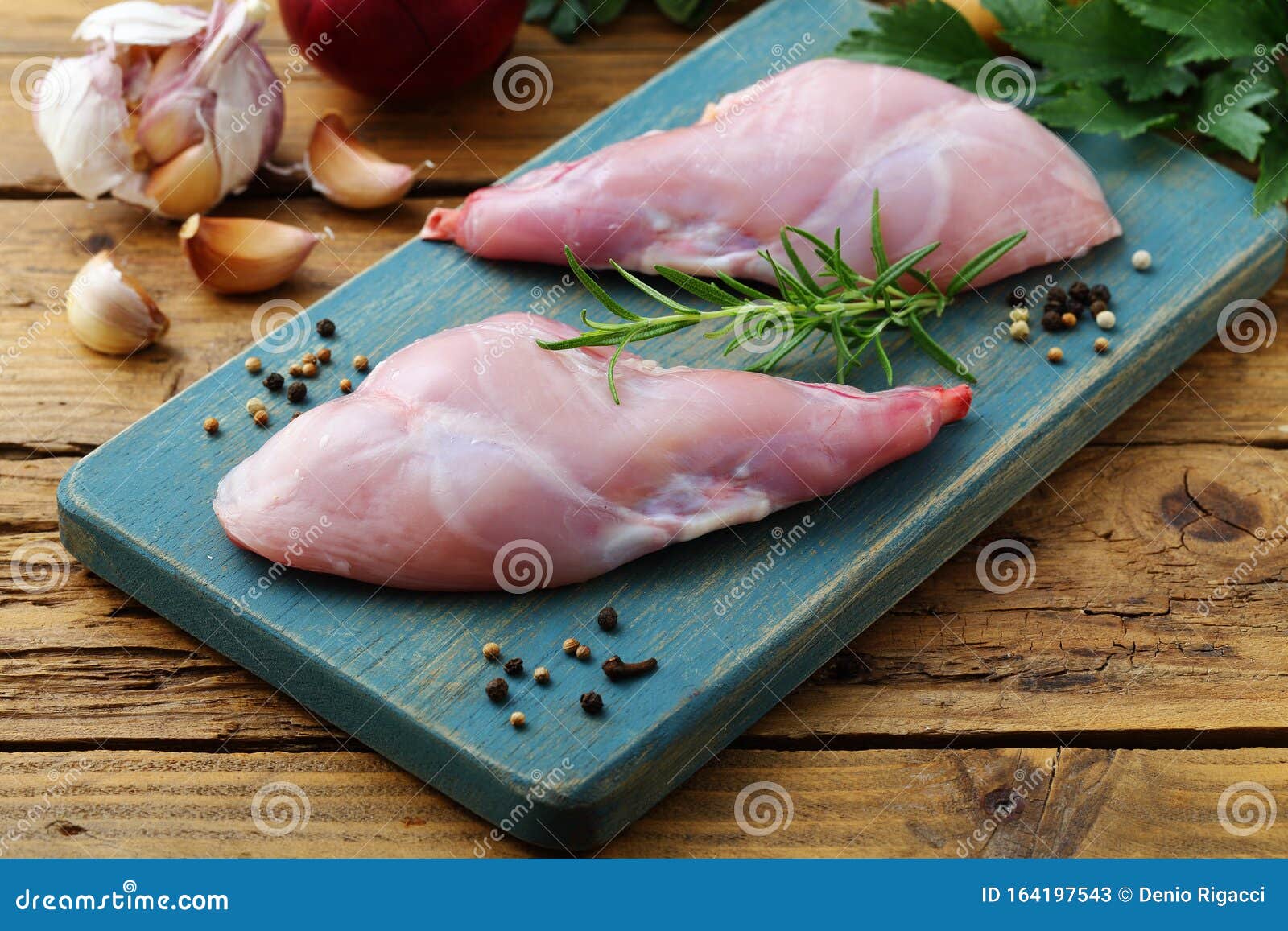 Raw Rabbit Slices with Spices Garlic Fork and Butcher on Rustic Stock ...