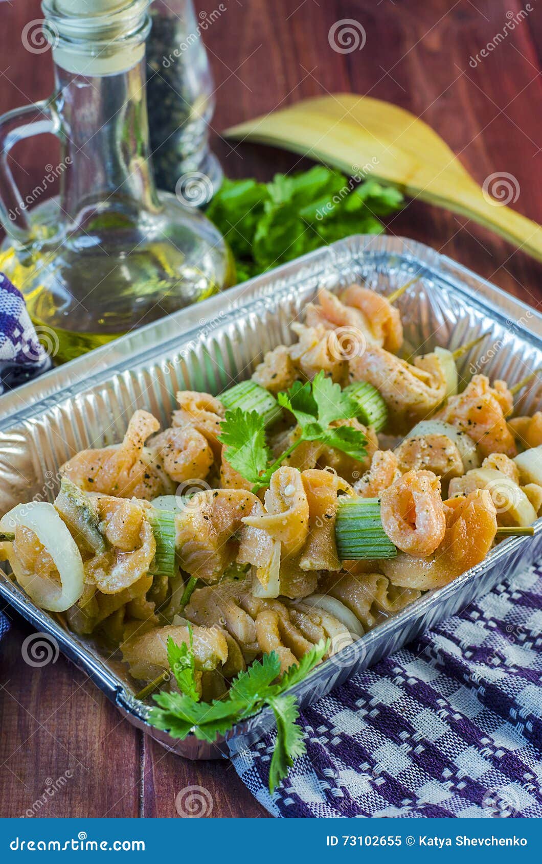 Raw red fish on skewers, ready to bake