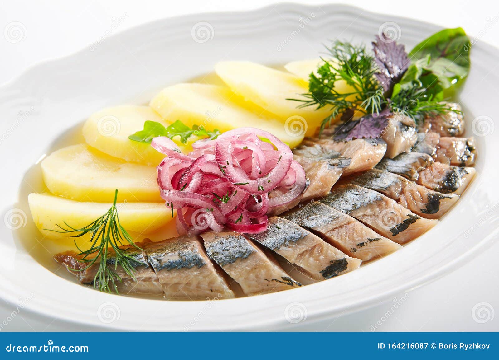 raw salted soused herring with onions and potato 