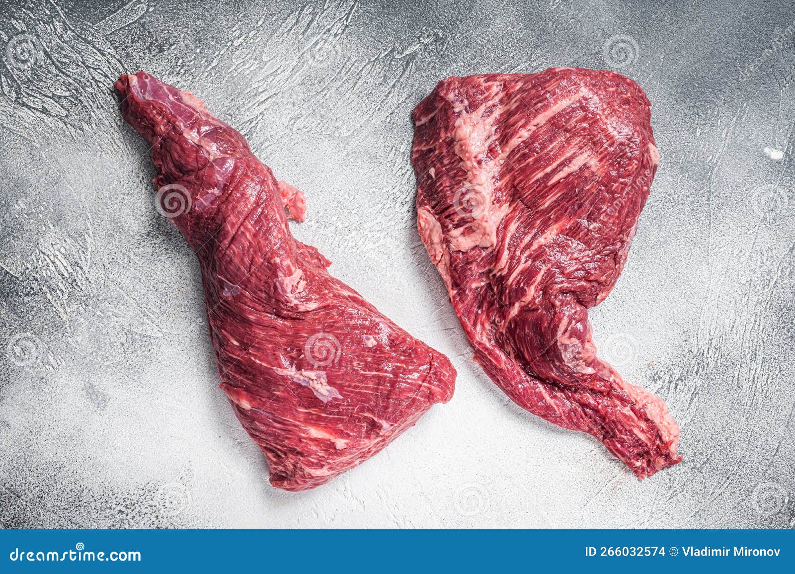 raw tri tip beef steak on kitchen table. white background. top view