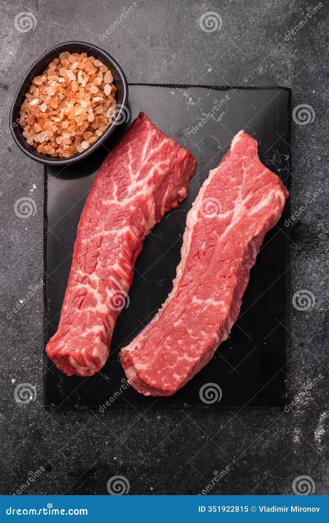 raw tri tip steak from black angus beef meat . black background. top view