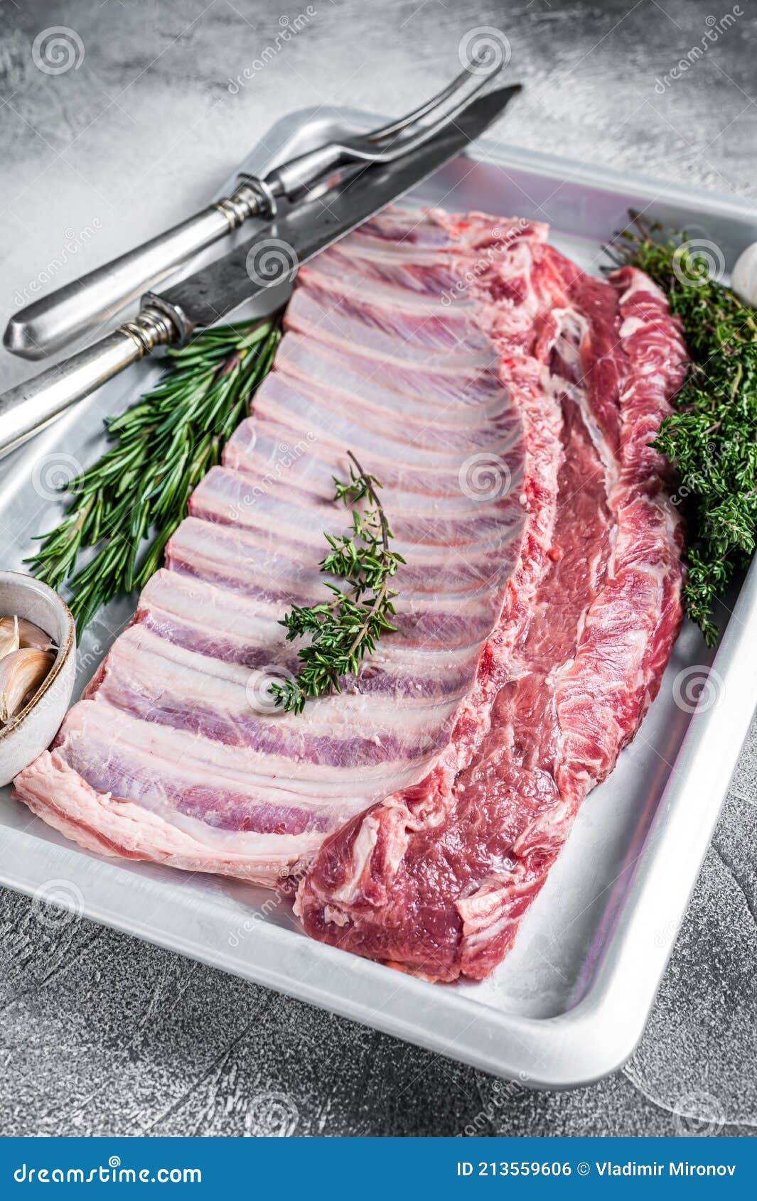 Raw Uncooked Rack of Mutton Lamb Ribs in Baking Dish. White Background