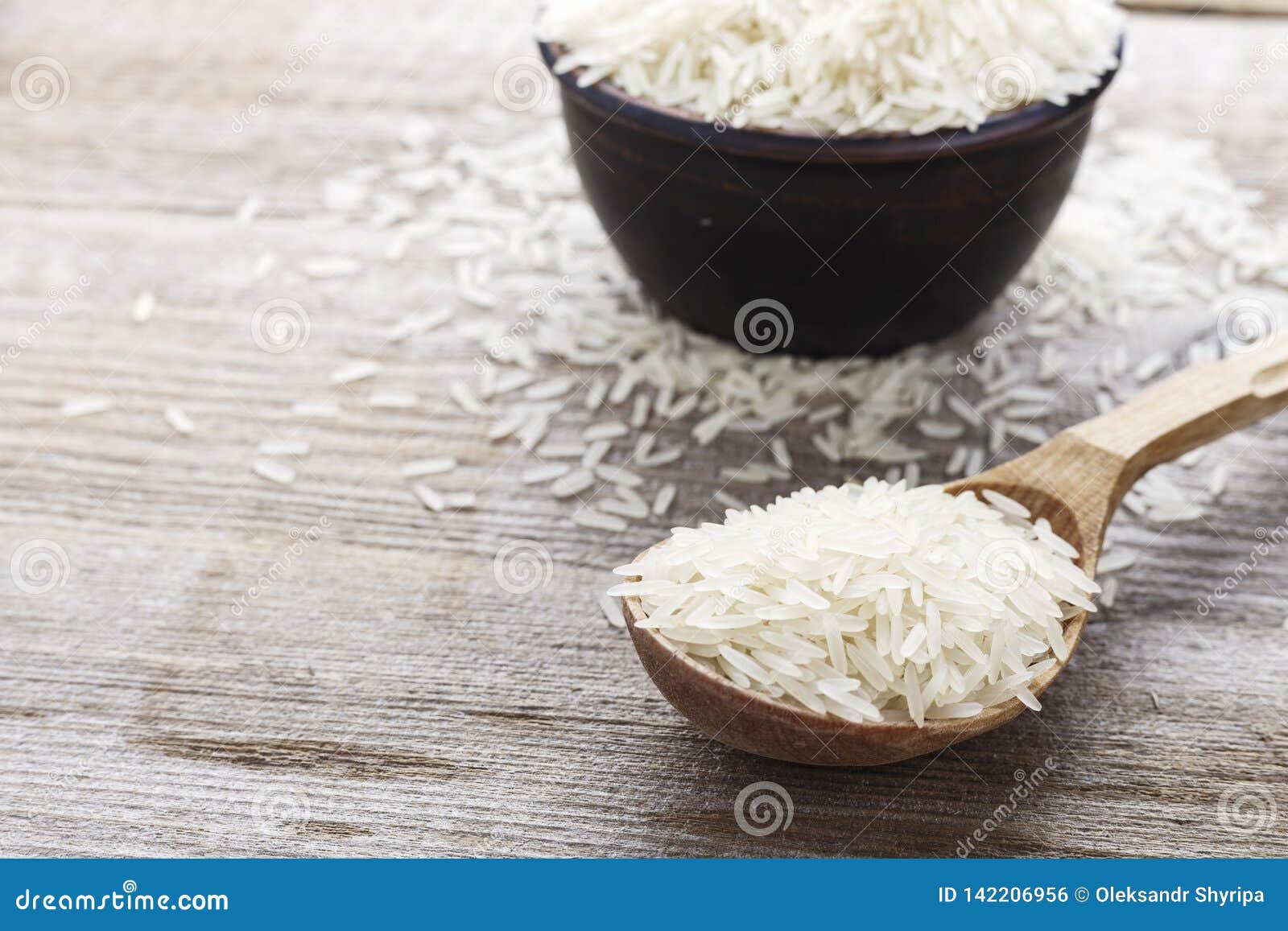 Raw white rice in a spoon stock photo. Image of closeup 142206956