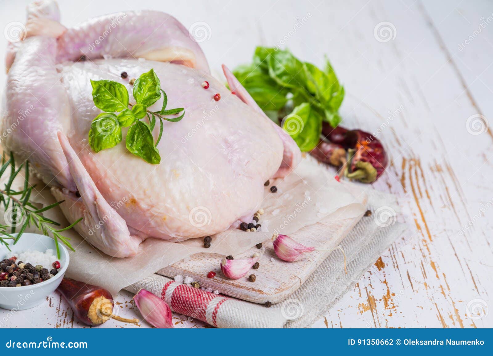 Raw Whole Chicken with Herbs and Spices on Rustic Wood Background Stock