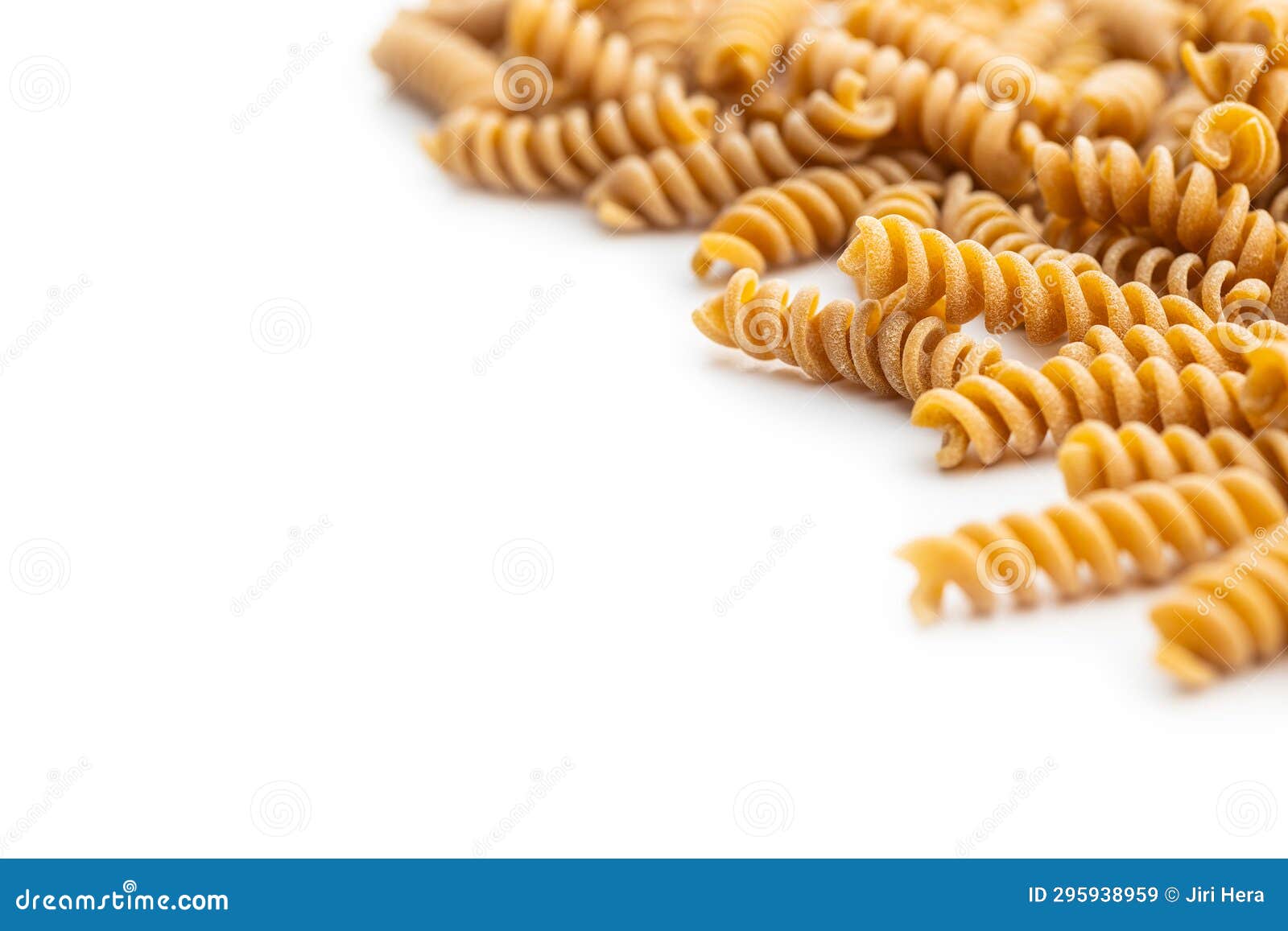 Raw Whole Grain Fusilli Pasta. Uncooked Pasta Isolated on White