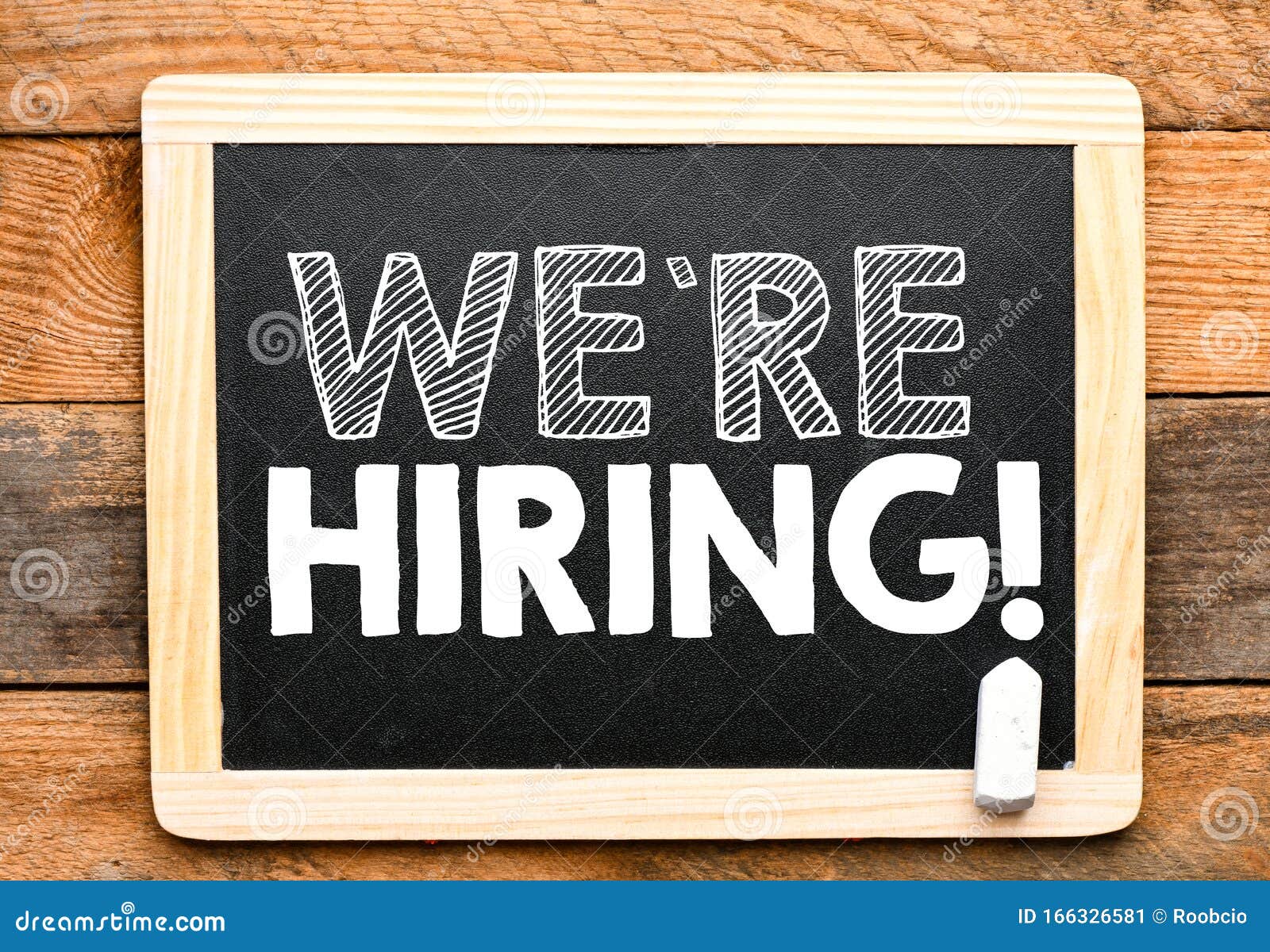 We`re Hiring Text on a Chalk Board Situated on a Wooden Table. Top View