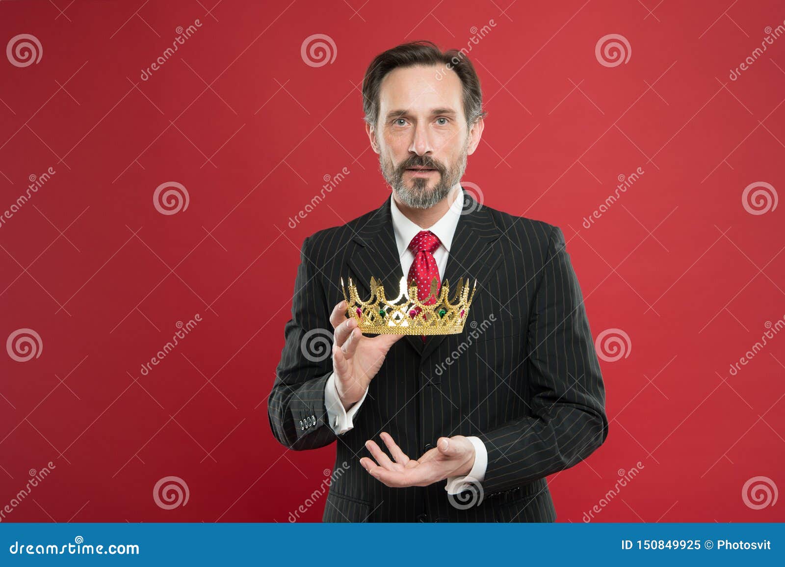 reaching the height of luxury and elegance. mature man holding luxury crown jewel on red background. successful
