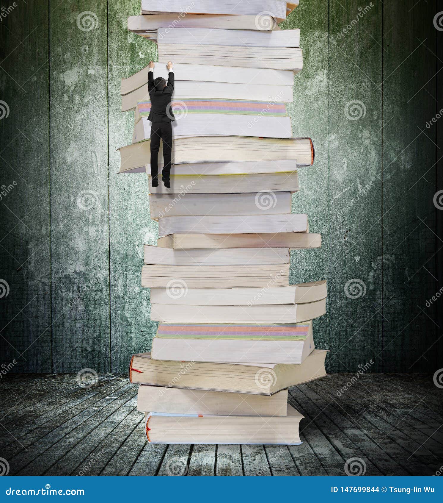 High Stack of Books with Climbing Businessman Hang on it Stock Photo ...