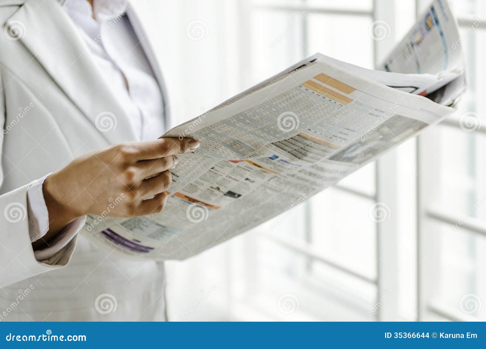 Reading printing media. Closeup woman hand holding newspaper